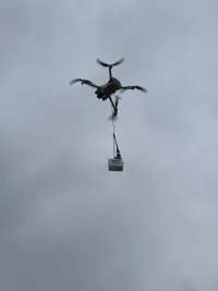 LilyGo T-Echo device hanging from a drone